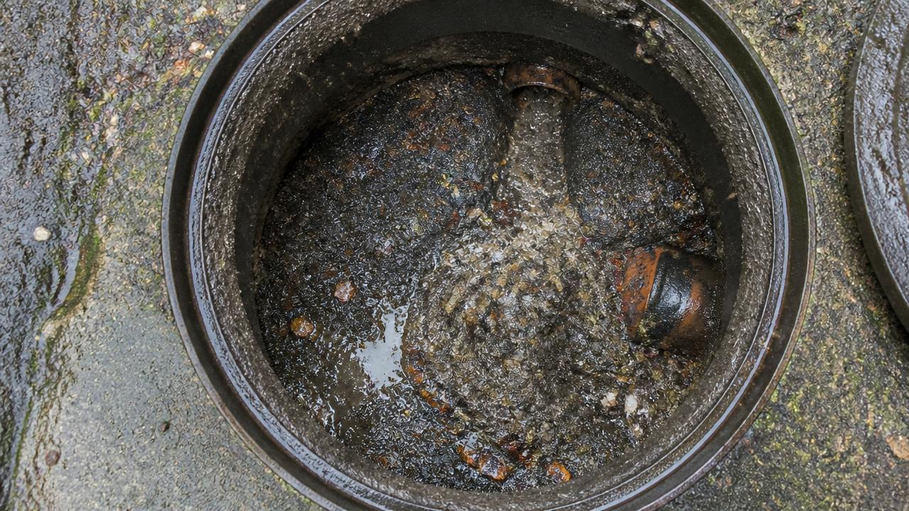 Blocked Glasgow drain before jetting, clogged with sludge and debris